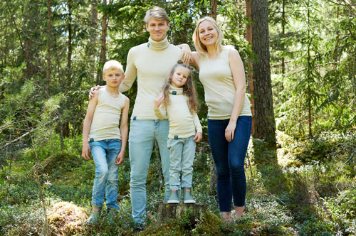 Children and adults wearing Ruskovilla's Metsä (Forest) Re-Connecting Nature shirts and tube scarfs